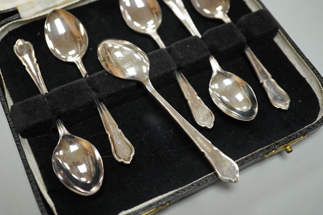 A Portuguese white metal 916 standard circular box and cover, retailed by Joalharia Do Carmo, diameter 94mm, together with cased set of six silver plated coffee spoons, a cased silver teaspoons, a Victorian silver christ
